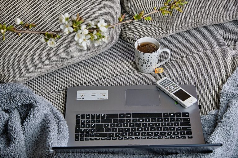 Thé et ordinateur portable sur le canapé